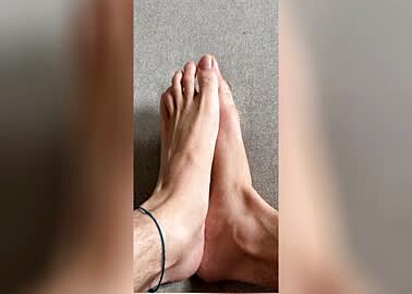 young guy rubbing his feet together